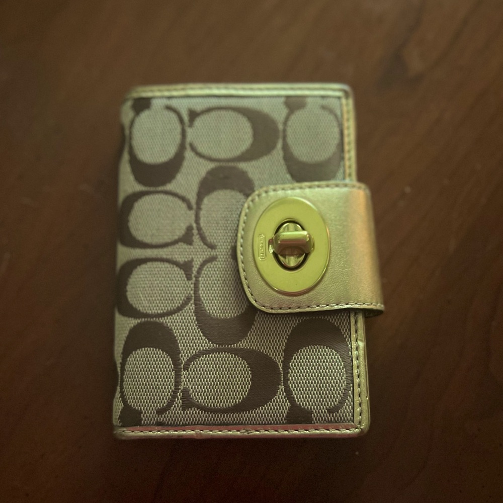 Coach gold wallet.